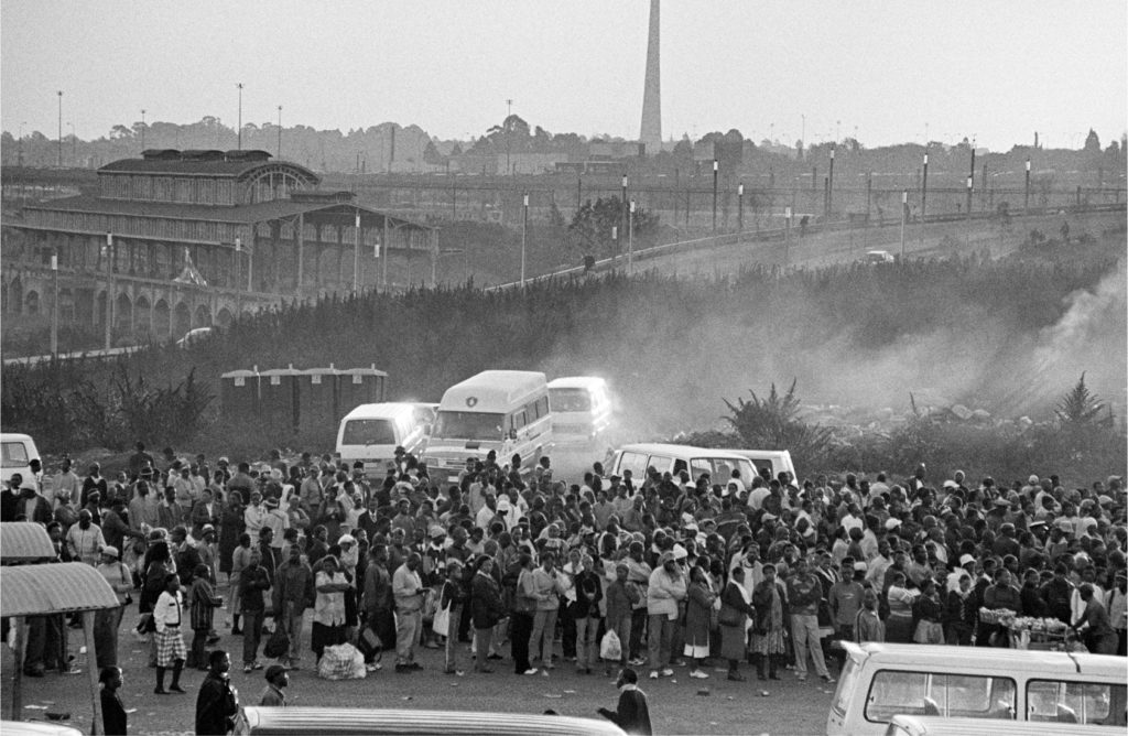 ANDREW TSHABANGU, Commuters and Taxis, Bree Street, City in Transition series,2004, Courtesy SEPTIEME Gallery and the Artist